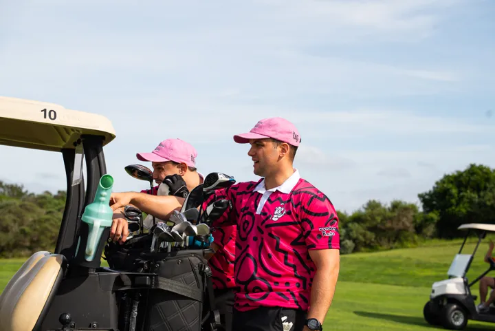 Golfers beside their cart